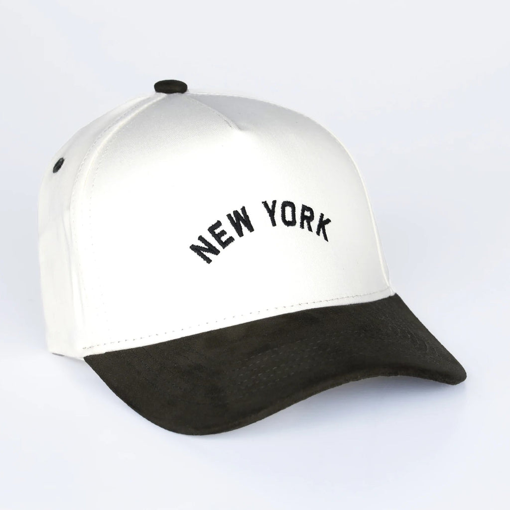 White and black cap with 'New York' text on a light gray background