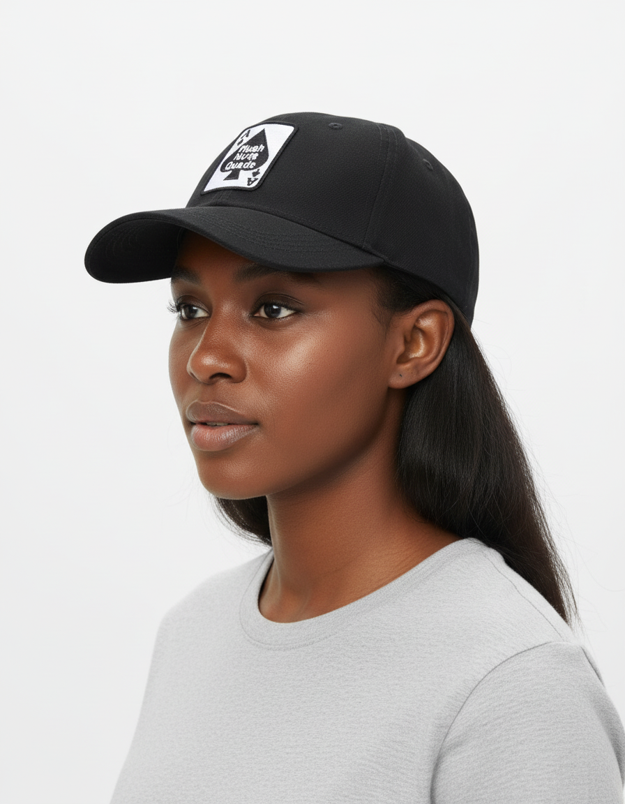 Woman wearing a black cap with a logo on a white background