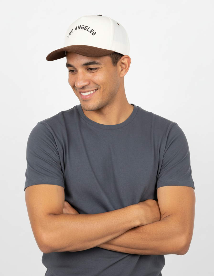 Man wearing a gray t-shirt and white cap with 'Los Angeles' text on a light gray background